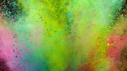 Explosion of colored powder on black background