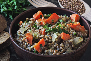 Buckwheat porridge with vegetables and herbs in a bowl. Flat lay. Healthy vegan food concept. Buckwheat diet