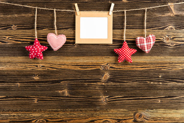 Hearts and stars on wooden background