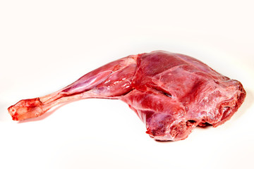 raw goat meat of leg on white background
