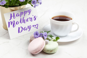 Happy Mother's Day postcard on white marble table