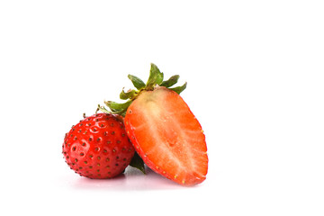 Half and whole strawberries isolated on white background