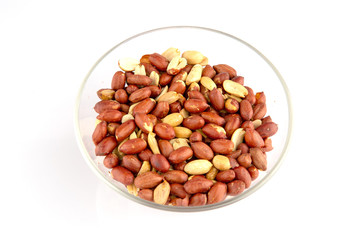 Roasted peanuts in a glass plate isolated on white background