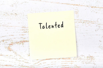 Yellow sticky note with handwritten word talented