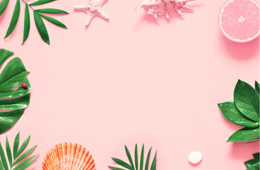 Fototapeta na wymiar Tropical background. Palm trees branches with starfish and seashell on pink background. Travel.