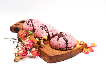 Cashew souffle cakes with beetroot powder on a pillow of crushed nuts and dried figs. Vegan, dietary raw sweets.