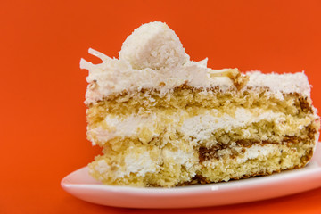 Piece of cake isolated on orange closr up