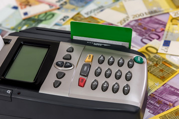 Terminal with credit card and euro banknotes