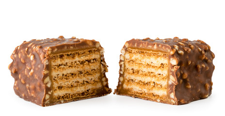 Two halves of chocolate candy with waffles and nuts on white, isolated.