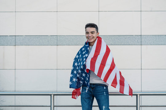 Young boy with the American flag on the street