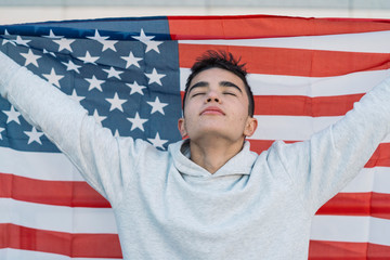 Young boy with the American flag on the street