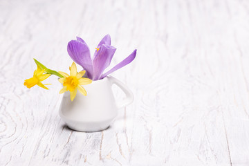 Bright fresh spring flowers on old wooden background