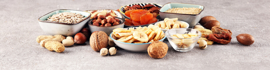 dried fruits and assorted nuts composition on rustic table