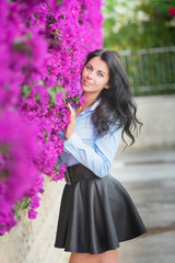 Beautiful young woman on a background of pink flowers. The concept of beauty and health. Beautiful fashion bride, sweet and sensual.