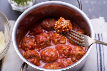 close up of meatballs, tomato sauce and mash