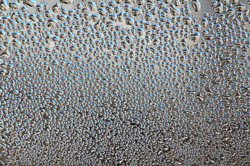 Drops of water on the glass, closeup. Colorful abstract background. Beautiful texture. Background image for design.