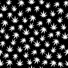 Seamless vector pattern. A lot of cannabis leaves. White on a black background