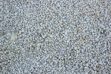 white crushed stones background texture wallpaper pattern surface foreshortening from above