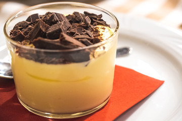 portion of Mascarpone con Scaglie di Cioccolato or Mascarpone cup with chocolate flakes italian traditional dessert