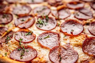 Pizza pepperoni on wooden table close up