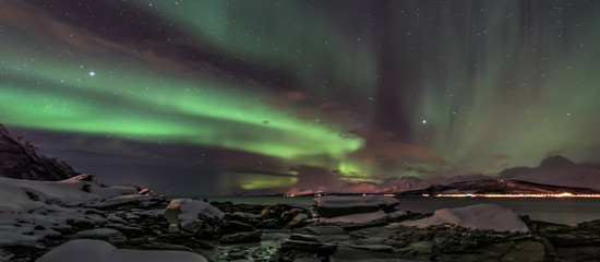 Amazing aurora borealis - northern lights - view from coast in Oldervik, near Tromso city -  north...