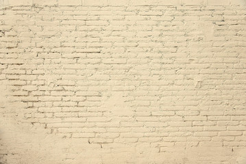 Old brick wall with beige paint background texture