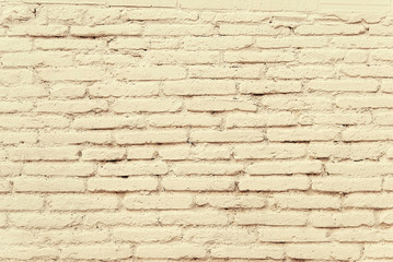 Old brick wall with beige paint background texture