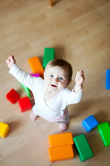  baby playing with plastic cubes