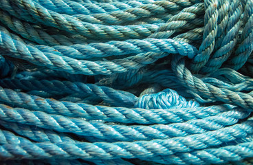 Coiled blue polypropylene rope weathered and showing signs of use