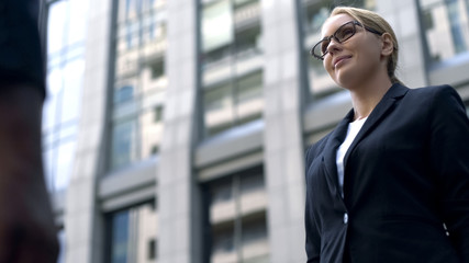 Successful woman standing against business center, female politician, statistics
