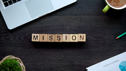 Mission word on wooden cubes, plan and goal achievement concept, organization