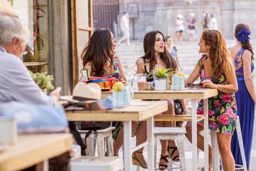 friends talking in a bar in summer