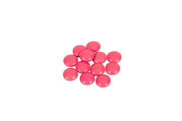 A scattering of pink pills, isolated on white background
