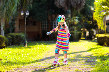Child on inline skates. Kids skate roller blades.