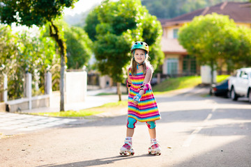 Child on inline skates. Kids skate roller blades.