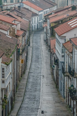 Fototapeta na wymiar Charming cobblestone streets in Santiago de Compostela, capital of Galicia, Spain. Its Old Town is a UNESCO World Heritage Site.