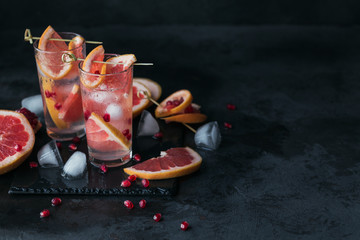 Grapefruit and pomegranate cocktail or mocktail, refreshing summer drink with crushed ice