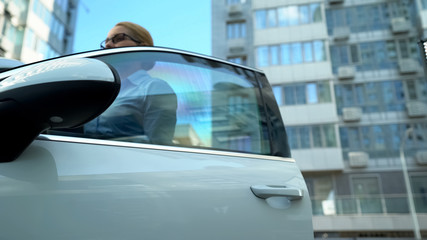 Fototapeta premium Lady in business suit getting into auto, hurrying to meeting with partners