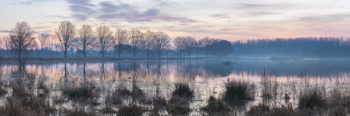 Fototapeta premium Early morning winter sunrise over lake, Broekpolder, Vlaardingen