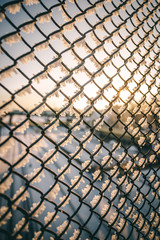 Chain link fence with barbed wire, background texture. 