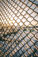 Chain link fence with barbed wire, background texture. 