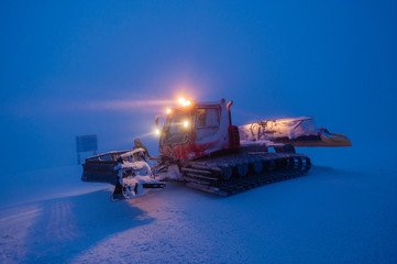 Snowcat grooming snow in the early morning, Stowe, Vermont, USA