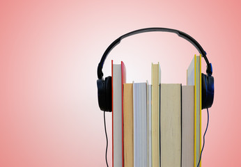 Headphones over books. Reading and Audio books concept