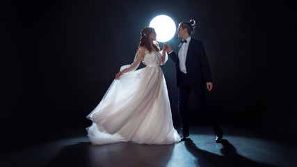 Mysterious and romantic meeting, the bride and groom under the moon. Hugs together. Man and woman,...