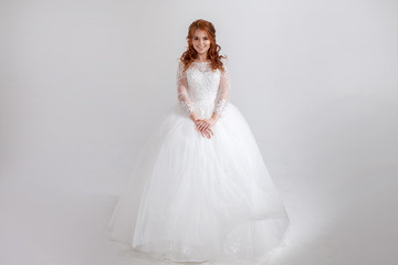 Fototapeta na wymiar Happy young woman bride in a lavish wedding dress.