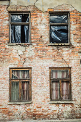 Fototapeta na wymiar Abandoned brick building with broken windows