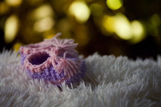 baby shoes wool background gold bokeh 