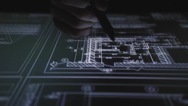 Creative Architect Working On Drawing Tablet pen display In night Office. drawings on the interactive screen