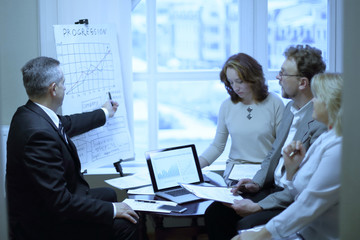 confident businessman showing business partners a new commercial