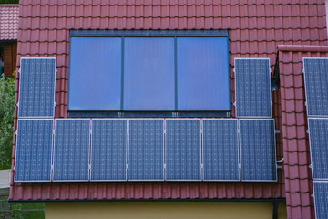 Solar panels on rood of modern resiadental house, renewable energy system.